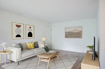 Reading apartment for rent - A living room with a white couch, a coffee table, and a painting on the wall.