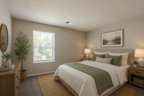 Columbia townhouse for rent - A bedroom with a large bed and a window.