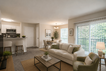 Columbia townhouse for rent - A living room with a white couch, a coffee table, and a dining area with a table and chairs.