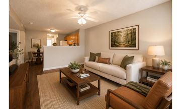 Anderson apartment for rent - A living room with a white couch, a coffee table, and a painting on the wall.