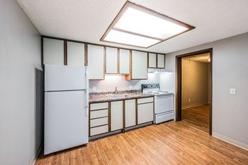 Hilliard apartment for rent - A kitchen with a refrigerator, sink, and cabinets.