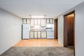 Louisville apartment for rent - A kitchen with white appliances and wooden floors.