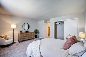 Indianapolis townhouse for rent - A bedroom with a large bed and a chair.