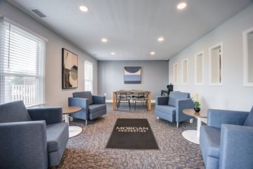 Indianapolis townhouse for rent - A waiting room with chairs and a table with a sign that says "MORGAN" on the carpet.