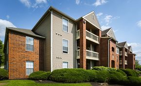 Cincinnati apartment for rent - A row of apartment buildings with balconies and brick exteriors.
