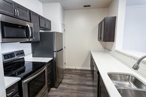 Beavercreek apartment for rent - A kitchen with black cabinets and stainless steel appliances.