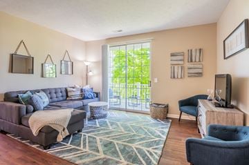 West Chester townhouse for rent - a living room with a couch and a tv and a sliding glass door