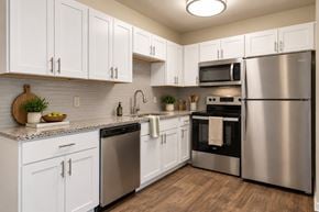 Fayetteville apartment for rent - A kitchen with white cabinets and stainless steel appliances.