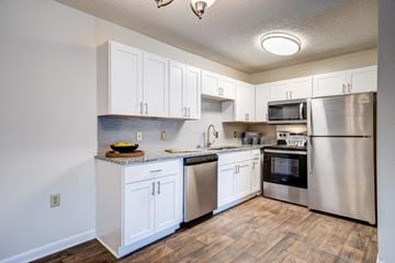 Fayetteville apartment for rent - A kitchen with white cabinets and stainless steel appliances.