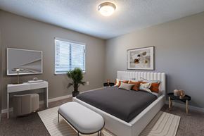 Concord apartment for rent - a bedroom with a bed and a desk and a mirror