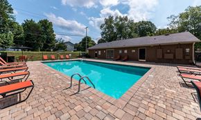 Concord apartment for rent - a swimming pool with chairs around it in front of a house