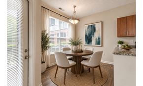 Fayetteville apartment for rent - A dining room with a round table and chairs.