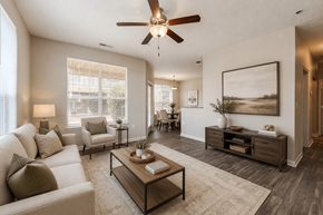 Fayetteville apartment for rent - A living room with a white couch, a coffee table, and a ceiling fan.