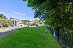 Monroe apartment for rent - a park with benches on the grass next to a fence