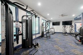 Fayetteville apartment for rent - A gym with a variety of equipment including treadmills, stationary bikes, and weight machines.