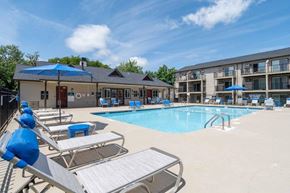 Rock Hill apartment for rent - A pool area with sun loungers and a building in the background.