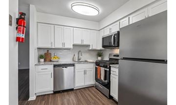 Allentown apartment for rent - A modern kitchen with white cabinets and stainless steel appliances.