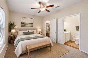 Lancaster townhouse for rent - A bedroom with a bed, a bench, and a ceiling fan.