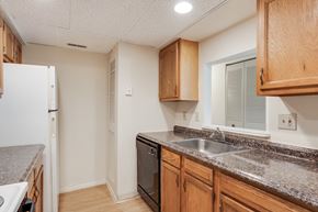 Cincinnati apartment for rent - A kitchen with wooden cabinets and a granite countertop.