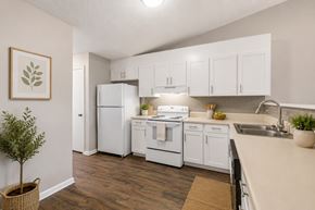 Monroe apartment for rent - A kitchen with white appliances and cabinets.