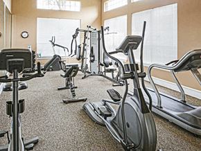 Cincinnati apartment for rent - A gym with a variety of exercise equipment including treadmills, stationary bikes, and elliptical machines.