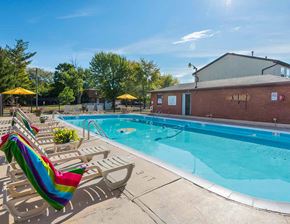 Middletown apartment for rent - A pool with a rainbow flag on a sunny day.