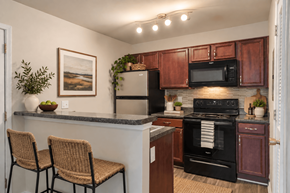 Columbia apartment for rent - A kitchen with brown cabinets and a black oven.