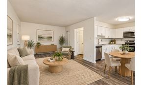 Lansdale apartment for rent - A well-lit, modern living room with a dining area in the background.