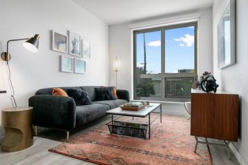 San Francisco apartment for rent - A living room with a black couch and a coffee table.
