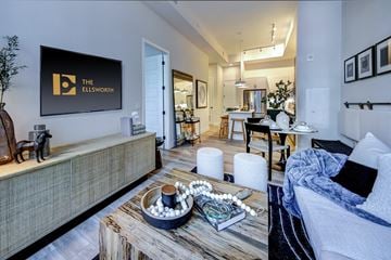 Plantation apartment for rent - A living room with a sofa, a coffee table, and a painting on the wall.