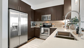 Atlanta apartment for rent - A modern kitchen with a stainless steel refrigerator and oven.