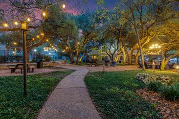 Evening-lit courtyard with central fire pit