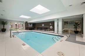 Salt Lake City apartment for rent - A large indoor swimming pool with a skylight above it.