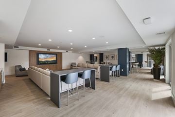 Salt Lake City apartment for rent - A modern living room with a large television and comfortable seating.