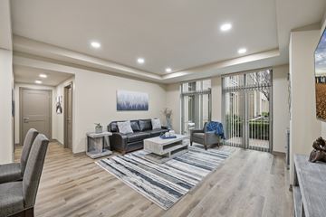 Salt Lake City apartment for rent - A modern living room with a grey sofa and a wooden floor.