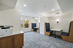 Ogden apartment for rent - a room with a printer and two tables with chairs