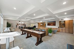 Ogden apartment for rent - A spacious room with a pool table and a bar area.