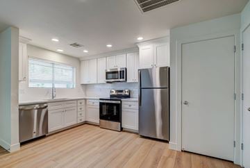 St. George apartment for rent - A kitchen with white cabinets and stainless steel appliances.