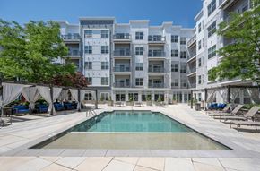 Cambridge apartment for rent - a swimming pool with an apartment building in the background