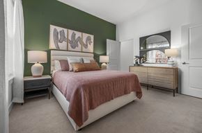 Cambridge apartment for rent - a bedroom with green walls and a bed with a brown blanket
