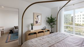 San Diego apartment for rent - A bedroom with a large bed and a painting on the wall.