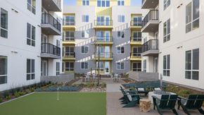 San Diego apartment for rent - Apartment complex with a green lawn and a playground.