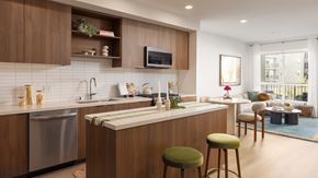 San Diego apartment for rent - A modern kitchen with wooden cabinets and a central island.