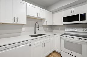 Salt Lake City apartment for rent - A white kitchen with a black microwave.