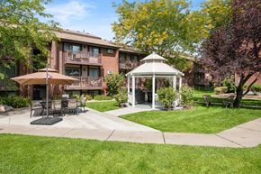 Salt Lake City apartment for rent - A gazebo is in the middle of a grassy area in front of an apartment building in salt lake city utah