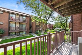 Salt Lake City apartment for rent - A view of a balcony with a railing and a building in the background.