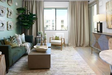 Mesa apartment for rent - a living room with a green couch and a table