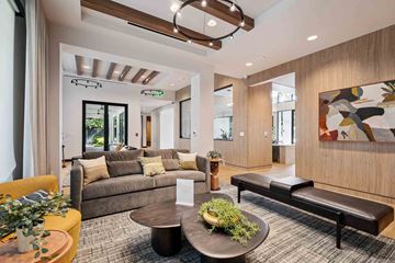 Austin apartment for rent - A modern living room with a large couch, a coffee table, and a painting on the wall.