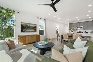 Saratoga Springs triplex for rent - A living room with a grey couch and a green couch.
