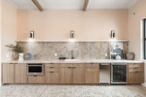 Saratoga Springs triplex for rent - A kitchen with wooden cabinets and a tile backsplash.